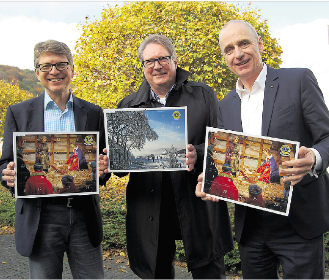 Michael Dassel (links) und Präsident Andreas P.. Amft von LC Neheim-Hüsten nehmen Karl-Heinz Müller Kalenderbeauftragter des LC Arnsberg-Sundern in die Mitte.